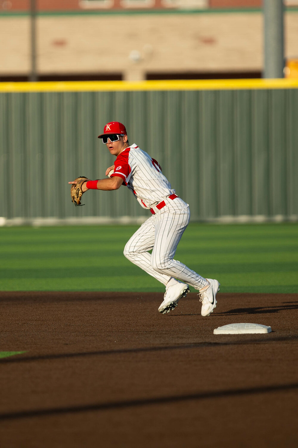 Graham Laxton throws a ball to first base during Thursday's Regional Quarterfinal game between Katy and Tompkins at Cy-Springs.